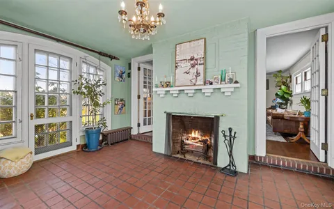a dining room with furniture a chandelier and wooden floor