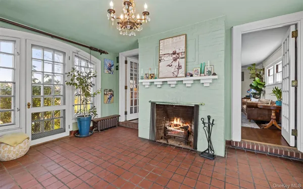 a dining room with furniture a chandelier and wooden floor