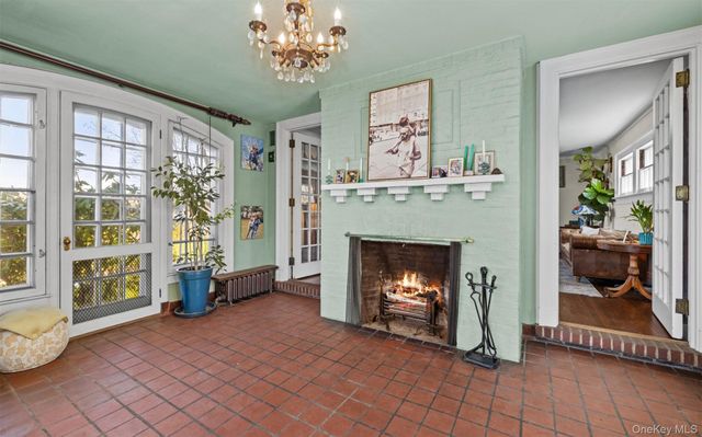 a dining room with furniture a chandelier and wooden floor