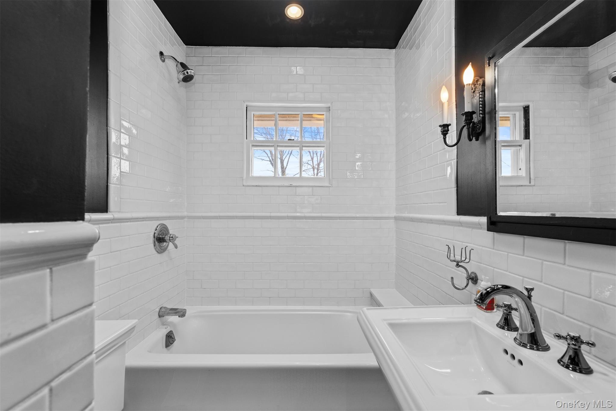 11-20 Shore Road Queens, NY 11363 - Photo 25 of 46 a bathroom with a tub sink and mirror