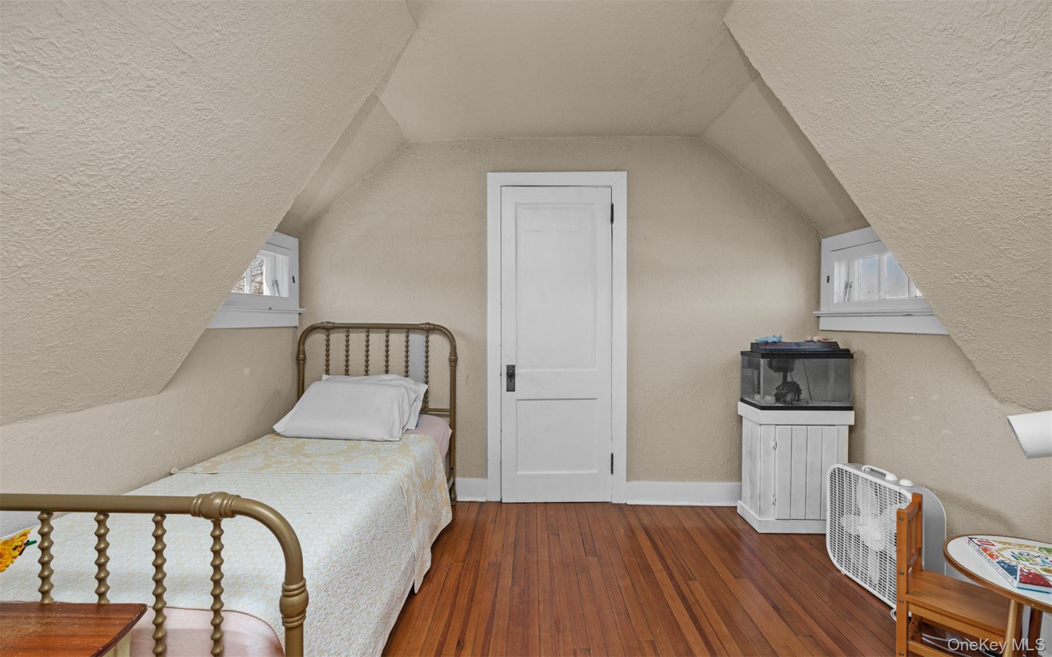 11-20 Shore Road Queens, NY 11363 - Photo 33 of 46 a bedroom with a bed and wooden floor