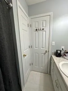 a bathroom with a sink a toilet a tub and shower