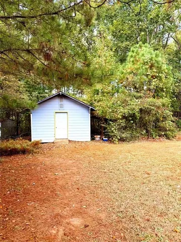 a house view with a swimming pool and wooden bench