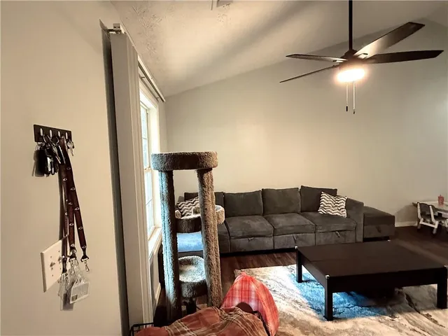 a living room with furniture and a mirror