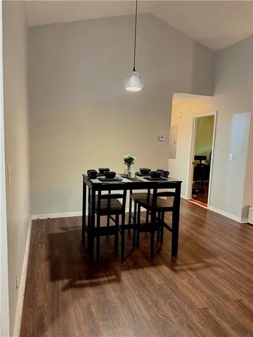 a view of a dining room with furniture and wooden floor
