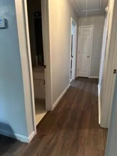 an empty room with wooden floor and closet