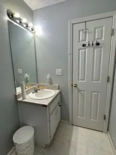 a bathroom with a sink a toilet and mirror