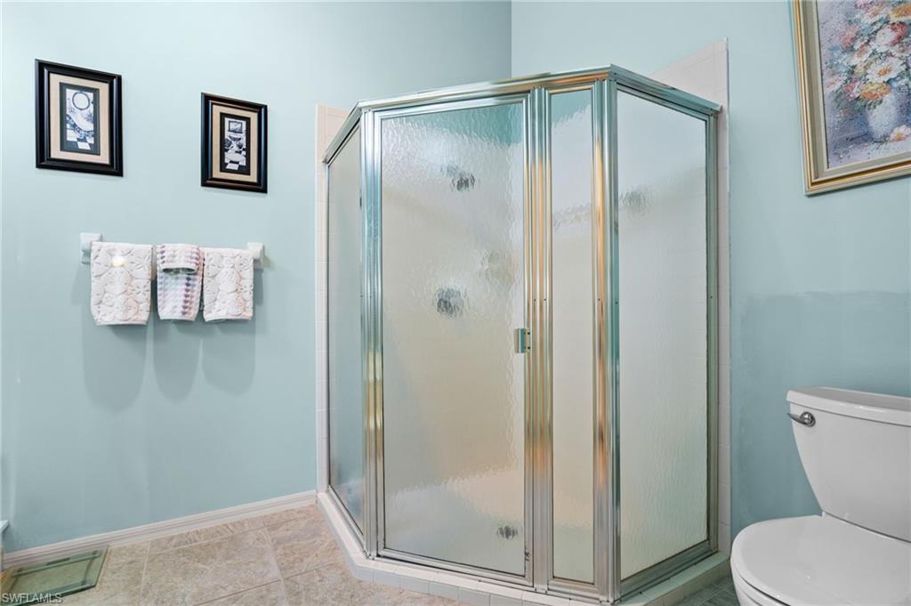 200 St James Way Naples, FL 34104 - Photo 19 of 45 Full bath featuring a shower stall and tile patterned floors