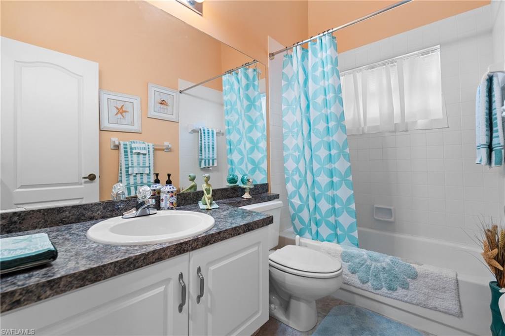 200 St James Way Naples, FL 34104 - Photo 24 of 45 Full bath with shower / tub combo with curtain and vanity