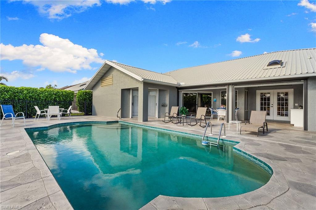 200 St James Way Naples, FL 34104 - Photo 26 of 45 View of swimming pool with a patio area and french doors
