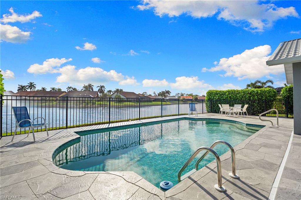 200 St James Way Naples, FL 34104 - Photo 28 of 45 View of swimming pool with a patio, a water view, and a residential view