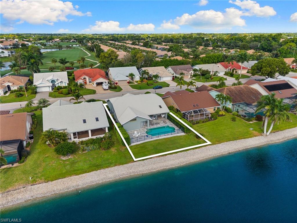 200 St James Way Naples, FL 34104 - Photo 33 of 45 Aerial perspective of suburban area with a nearby body of water and a golf course