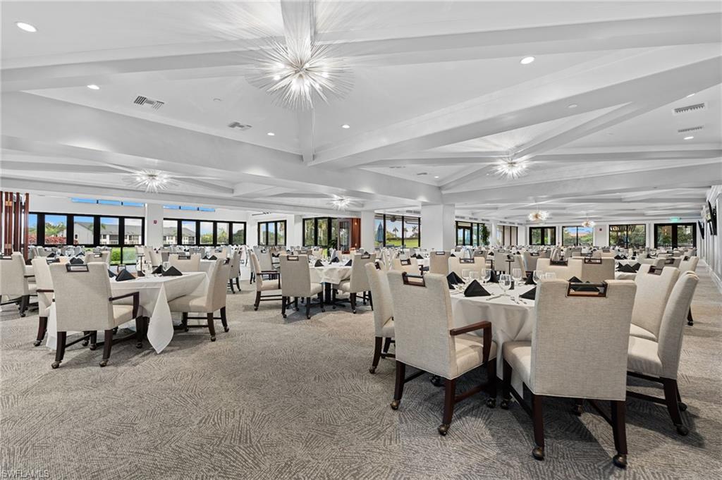 200 St James Way Naples, FL 34104 - Photo 38 of 45 Dining room with beamed ceiling, recessed lighting, healthy amount of natural light, light colored carpet, and a chandelier