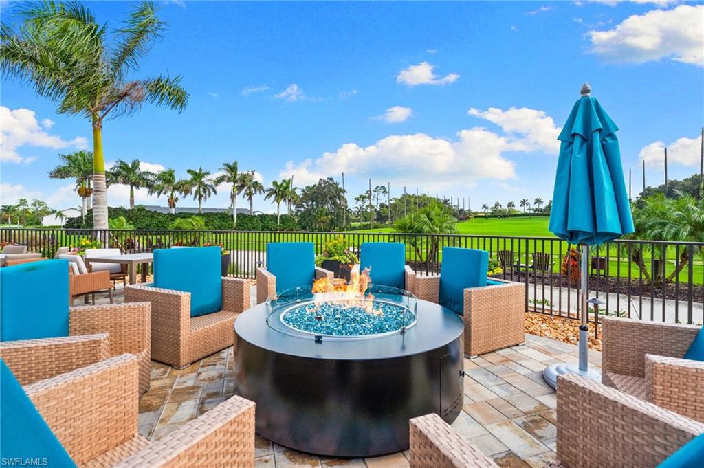200 St James Way Naples, FL 34104 - Photo 41 of 45 Wooden deck featuring an outdoor living space with a fire pit, view of golf course, and a patio area