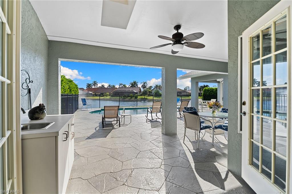 200 St James Way Naples, FL 34104 - Photo 7 of 45 View of patio / terrace featuring a ceiling fan and a water view