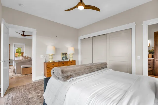 a bed sitting in a bedroom next to a window