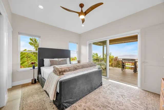 a balcony with wooden floor table and chairs