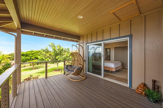 a bedroom with a bed a couch and a window