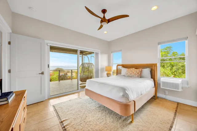 a bedroom with a large bed and a window