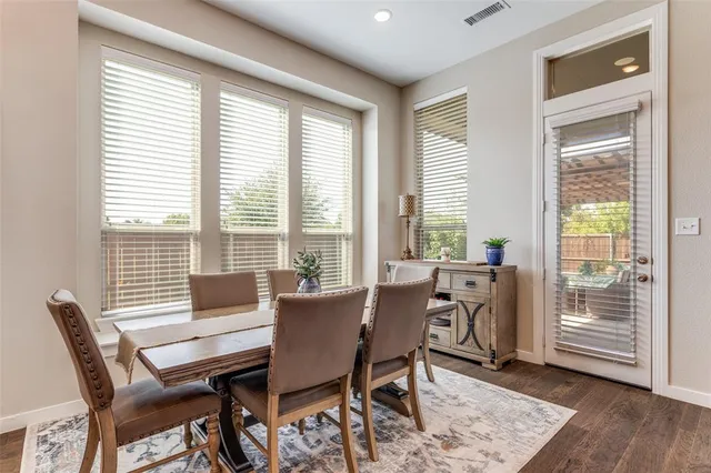 a view of a dining room with furniture and windows