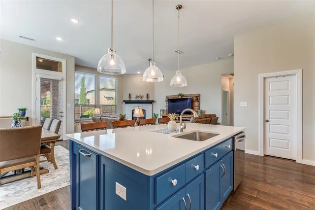 a kitchen with a sink refrigerator and cabinets