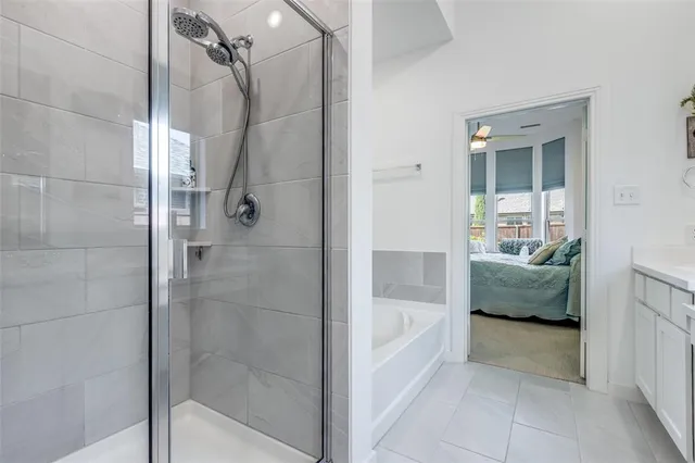 a bathroom with a tub shower and a sink