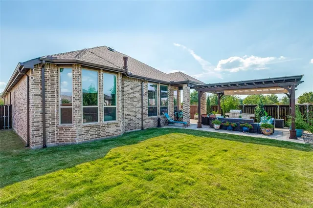 a view of a house with a yard and sitting area