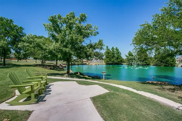 an aerial view of residential houses with outdoor space and lake view