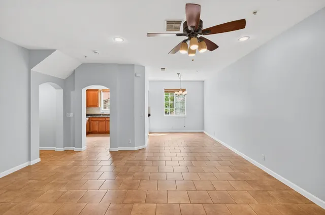 a view of a livingroom with a ceiling fan and window