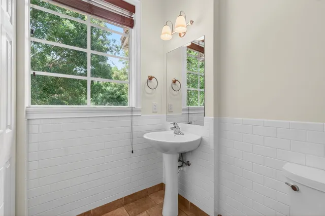a bathroom with a granite countertop tub sink and mirror