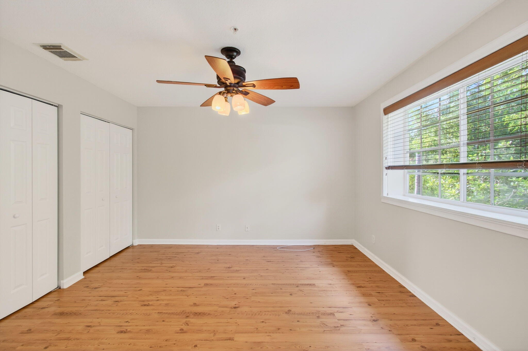 4582 Danson Way Delray Beach, FL 33445 - Photo 23 of 74 a view of empty room with wooden floor and fan