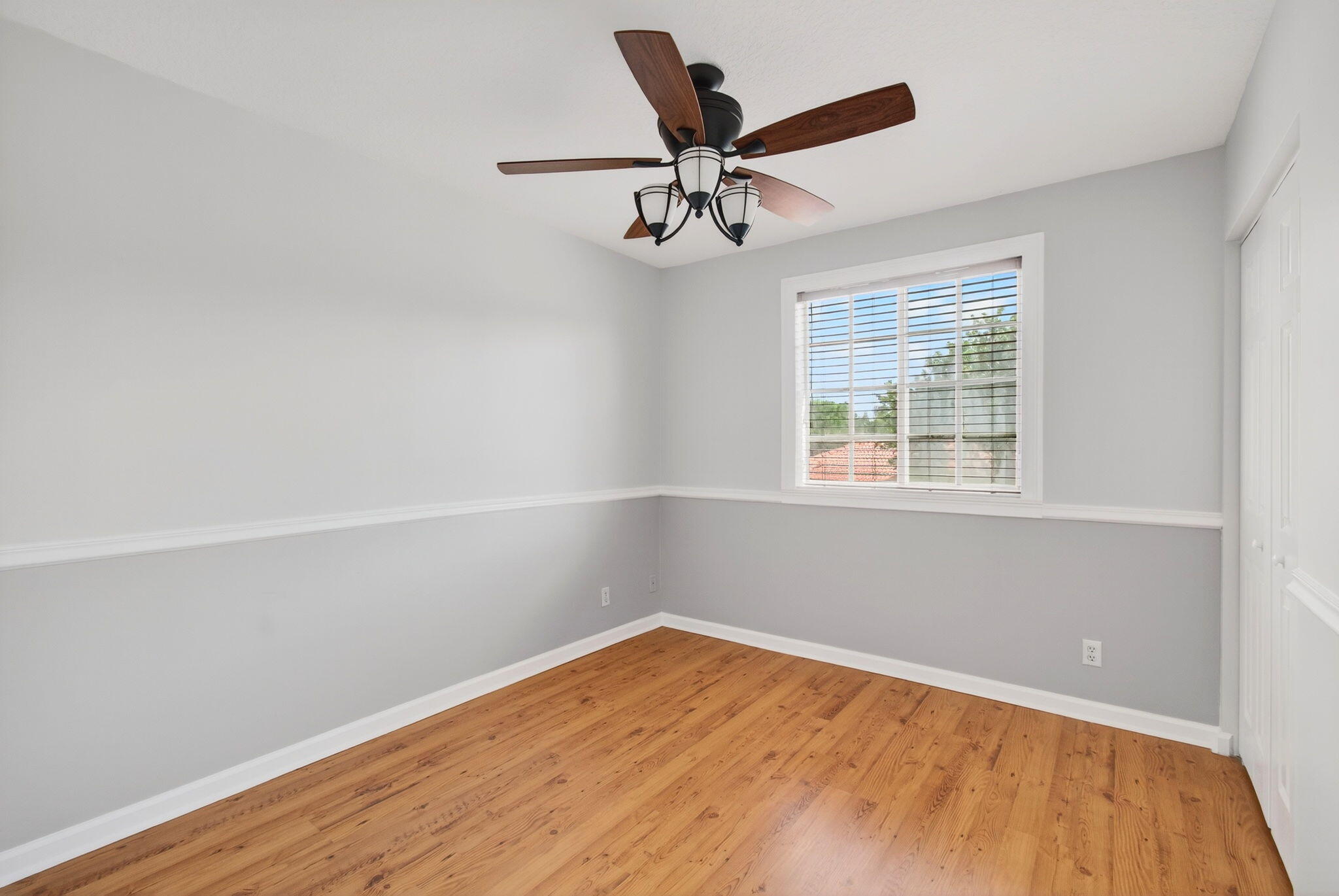 4582 Danson Way Delray Beach, FL 33445 - Photo 32 of 74 an empty room with wooden floor ceiling fan and windows