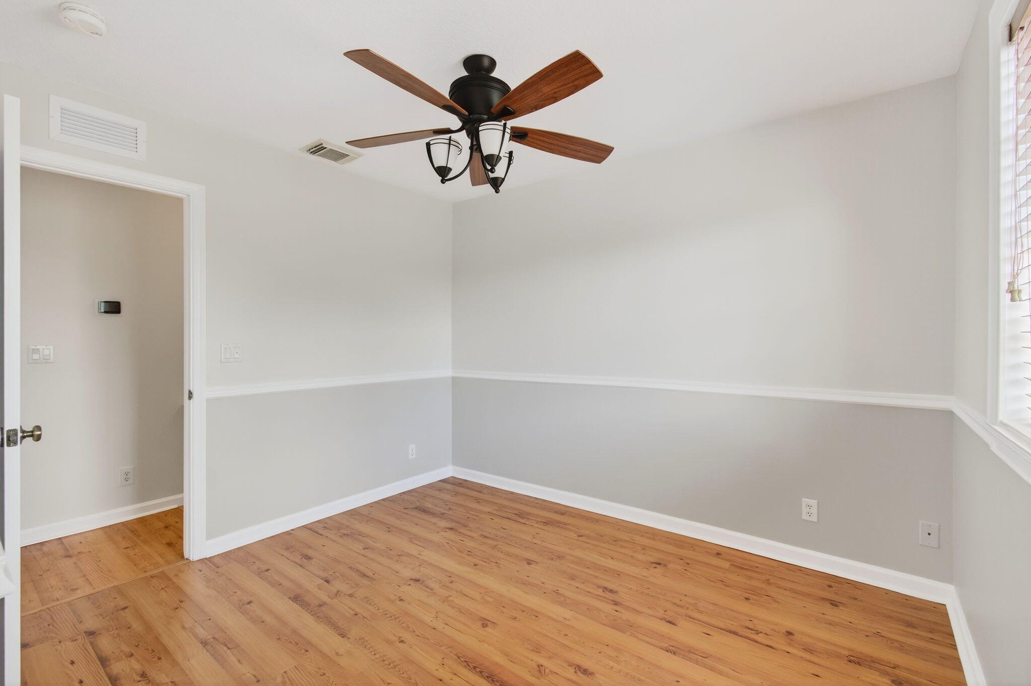 4582 Danson Way Delray Beach, FL 33445 - Photo 33 of 74 an empty room with wooden floor and a ceiling fan