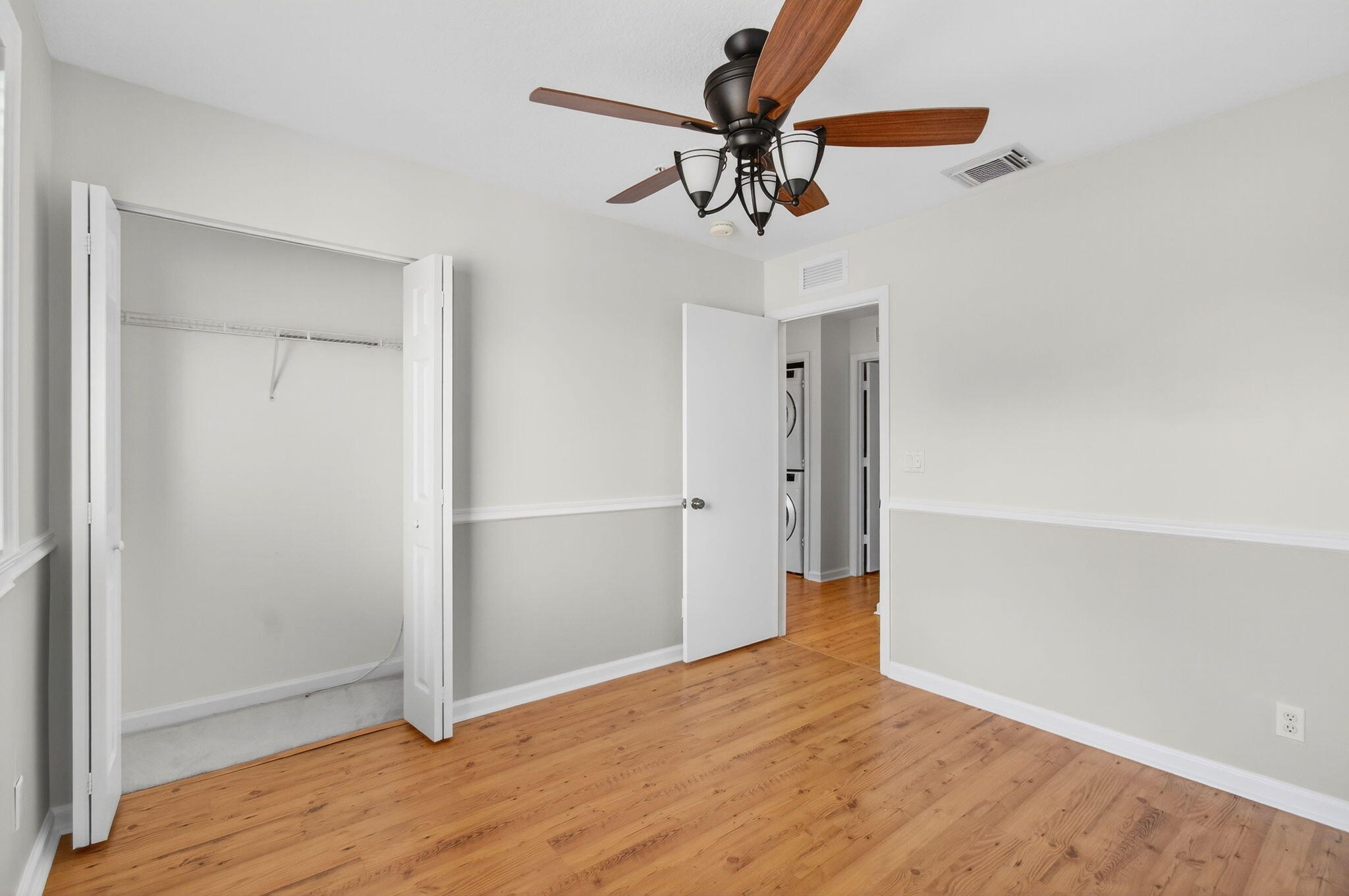 4582 Danson Way Delray Beach, FL 33445 - Photo 34 of 74 a view of empty room with wooden floor and ceiling fan