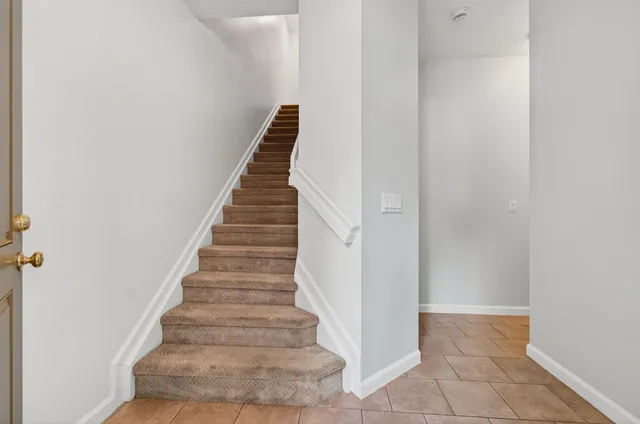 a front view of a house with a yard table and chairs