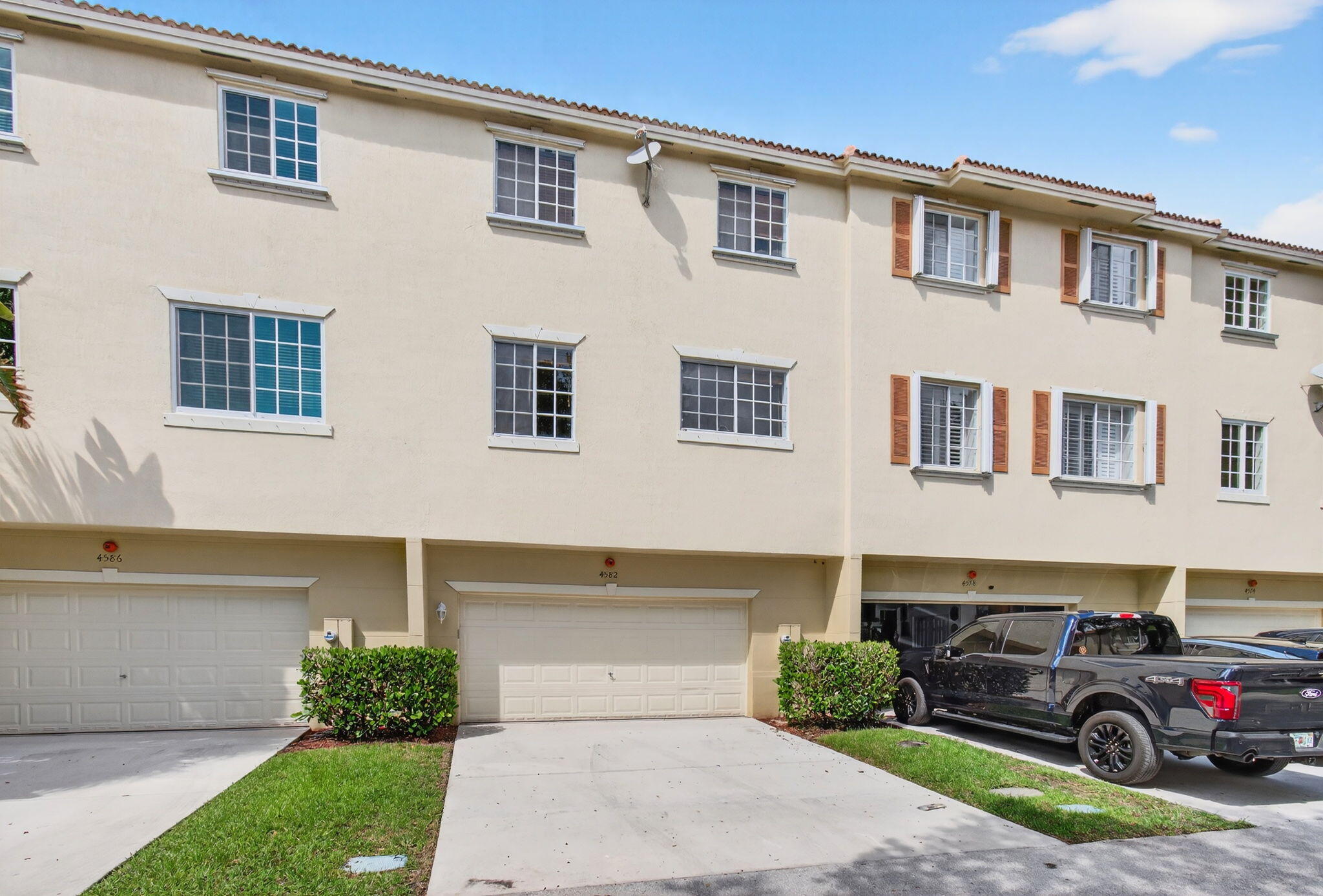 4582 Danson Way Delray Beach, FL 33445 - Photo 57 of 74 a front view of a house with a yard and garage