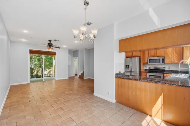 a view of a livingroom with a ceiling fan and window
