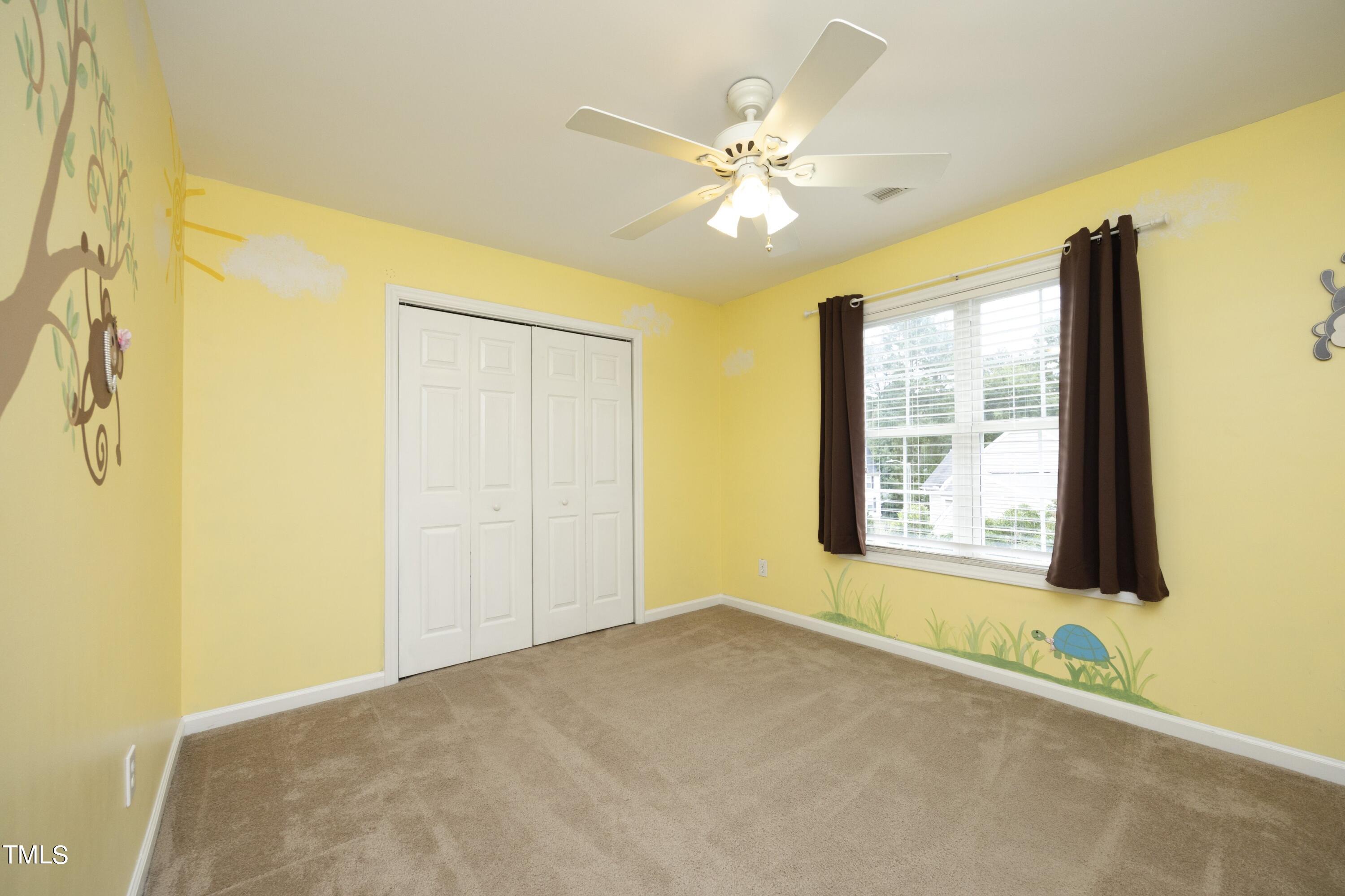 8904 Castleton Lane Raleigh, NC 27615 - Photo 27 of 43 a view of an empty room with chandelier fan and a window