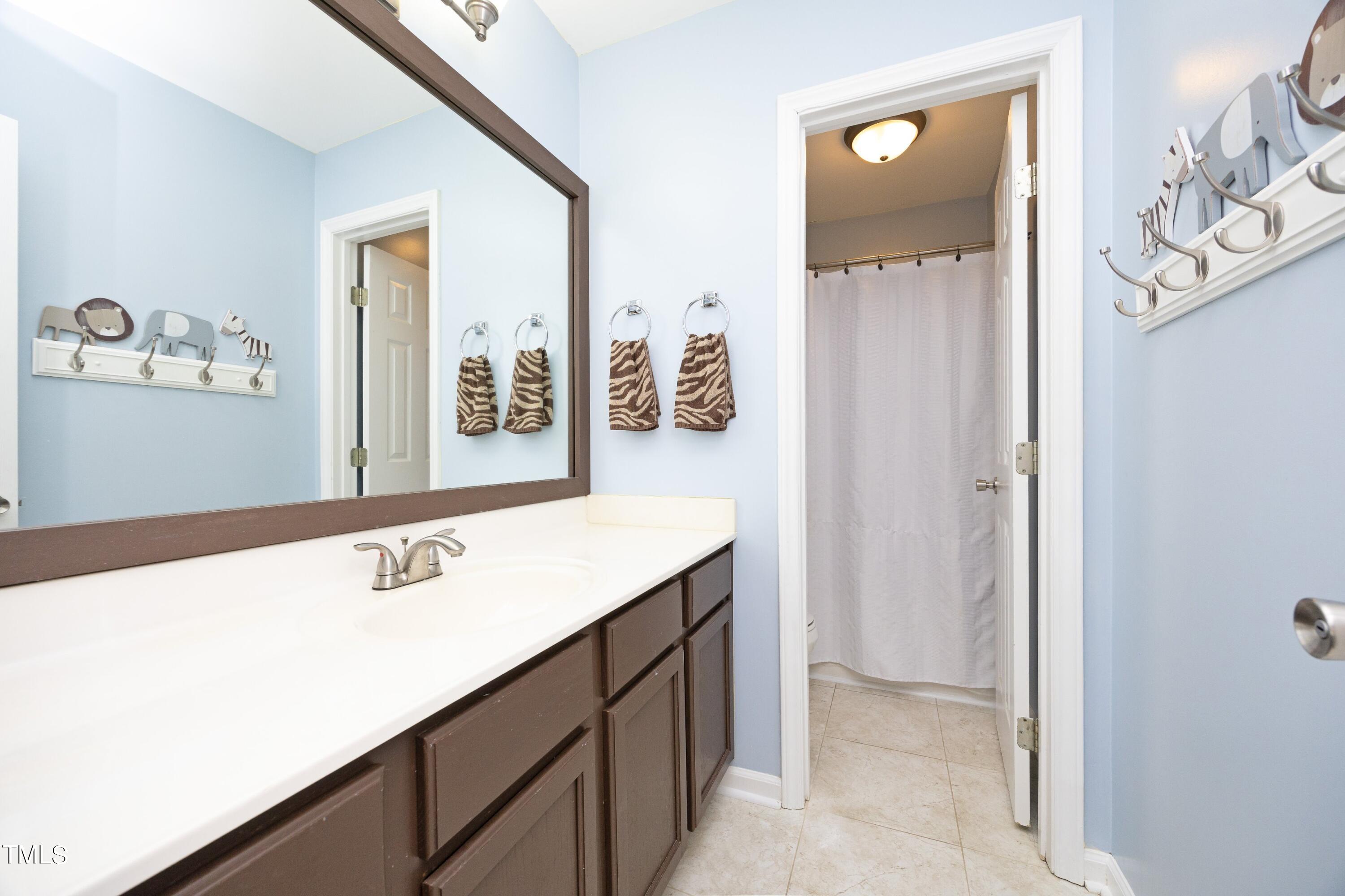 8904 Castleton Lane Raleigh, NC 27615 - Photo 29 of 43 a room with a sink vanity and mirror