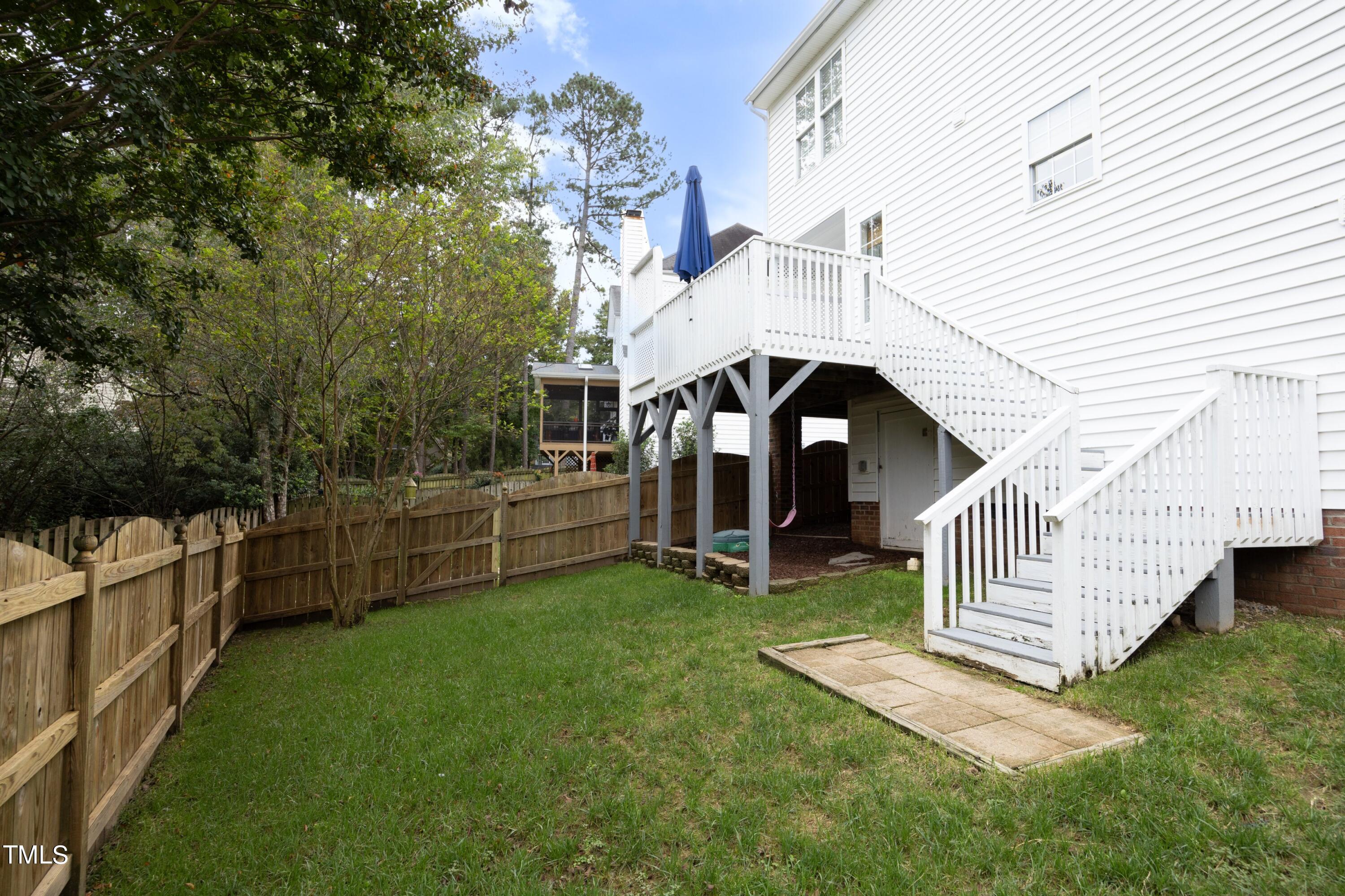 8904 Castleton Lane Raleigh, NC 27615 - Photo 33 of 43 a view of a house with a small yard and a wooden deck