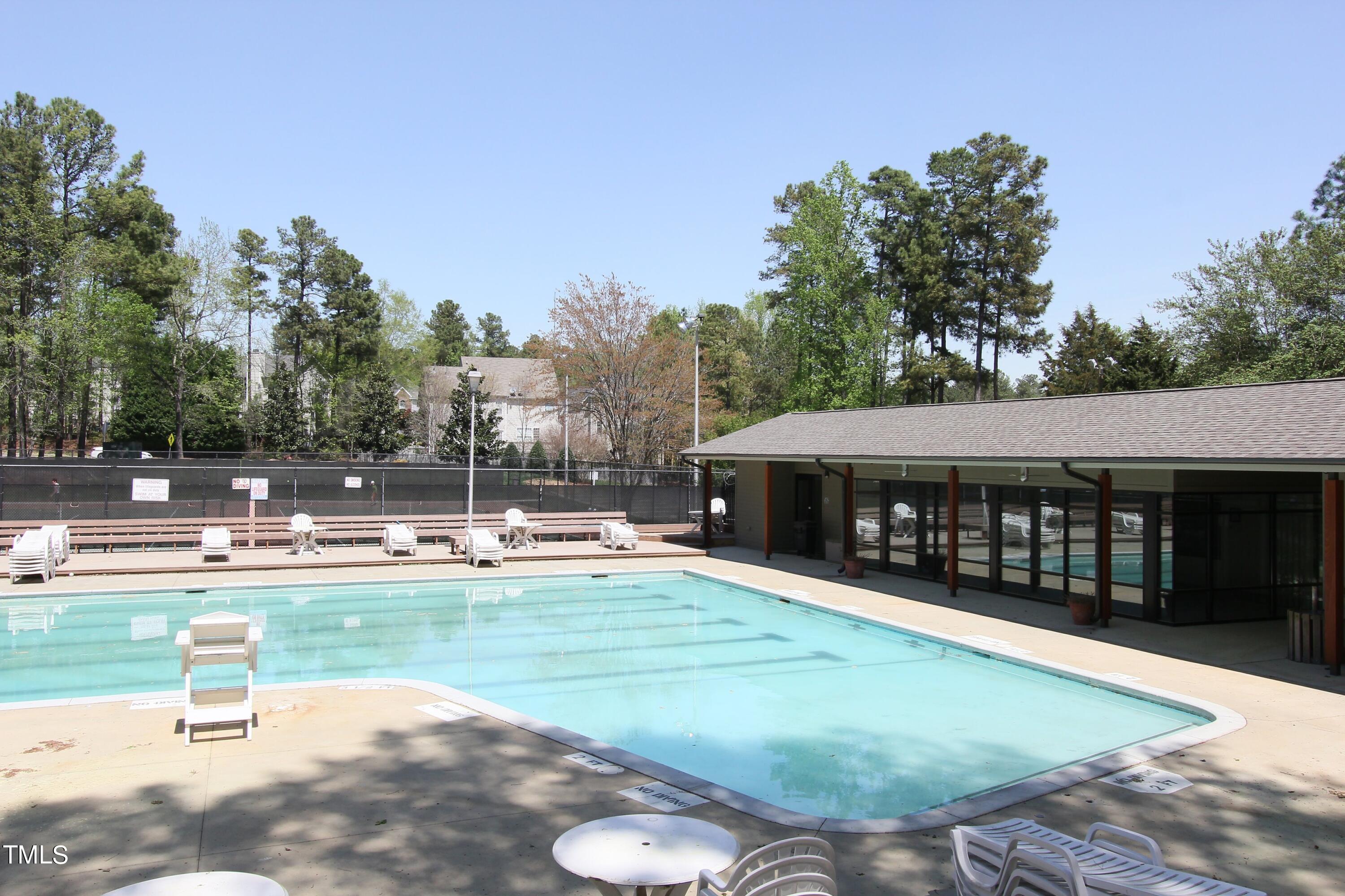 8904 Castleton Lane Raleigh, NC 27615 - Photo 39 of 43 a view of a swimming pool with a patio and a yard