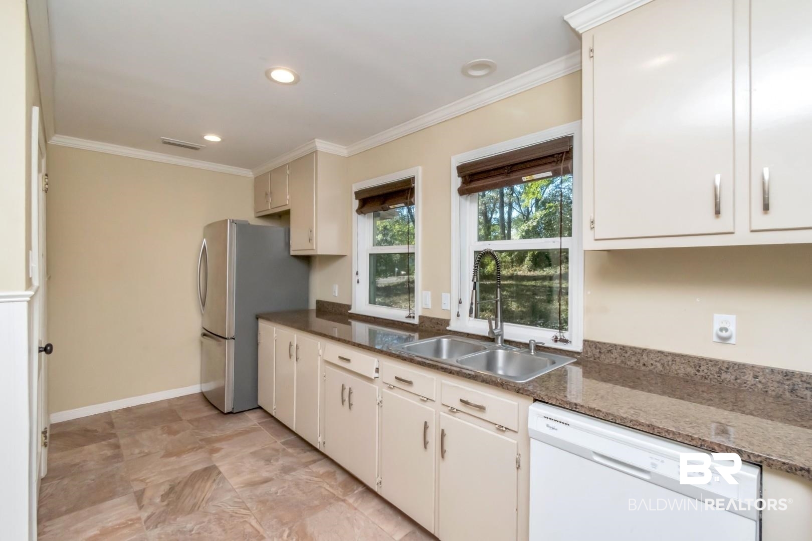410 St John Place Mobile, AL 36609 - Photo 10 of 32 Kitchen with dishwasher, crown molding, dark stone countertops, recessed lighting, and freestanding refrigerator