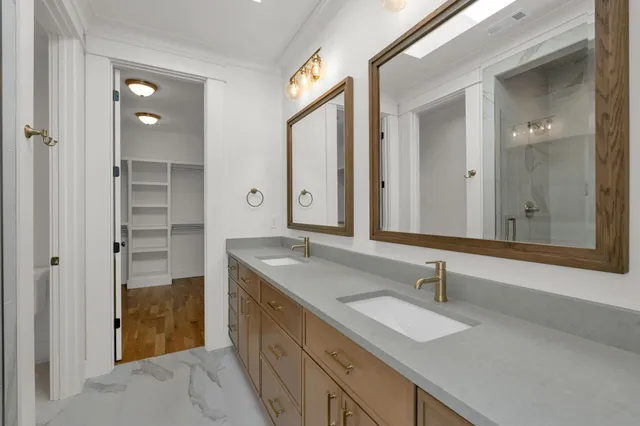 a spacious bathroom with a granite countertop sink mirror and shower