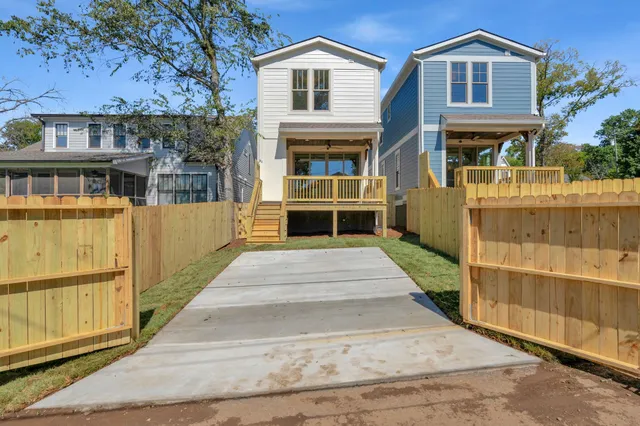 a view of a house with a wooden fence