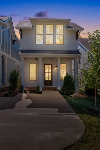 a view of a hallway with wooden floor windows and a livingroom