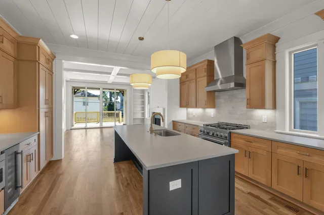 a kitchen with kitchen island a sink appliances and a counter top space