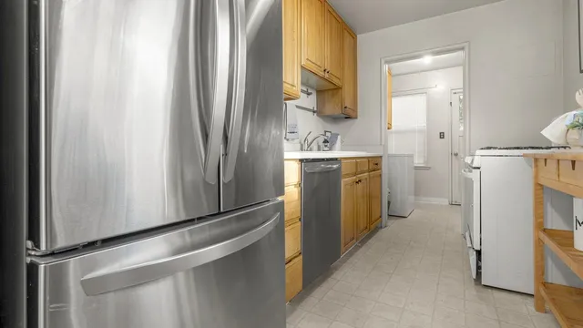 a kitchen with a refrigerator and a stove