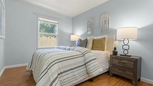 a bedroom with a bed and a lamp