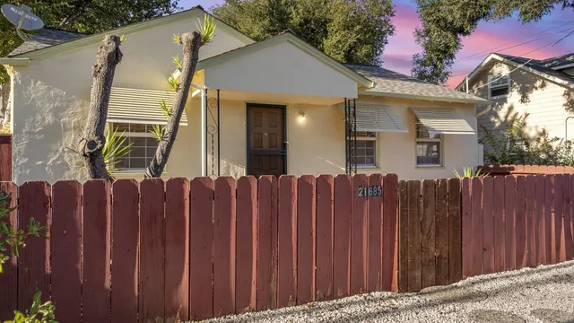 a view of a house with wooden fence