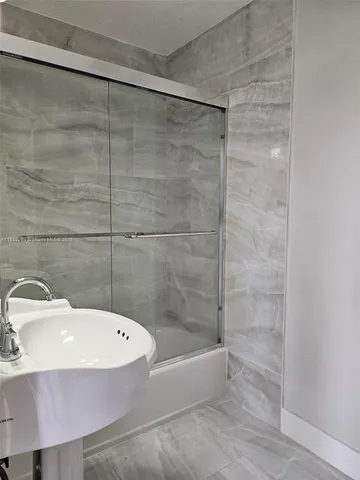 a bathroom with a sink and a shower